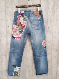 a pair of jeans with patches and flowers on them