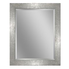 a square silver framed mirror on a white wall with an aged wood border around the edges