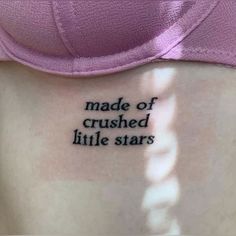 a woman with a tattoo that reads made of crushed little stars