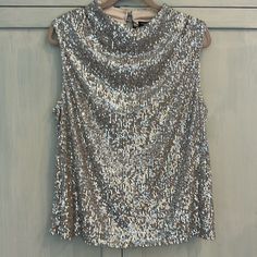 Brand New With Tags, Beautiful, Soft And Wearable Top Tiny Sequins In Silver With A Nude Lining That Is Soft And Has Some Stretch. Metallic Sleeveless Spring Top, Metallic Sleeveless Top For Spring, Glamorous Metallic Sleeveless Top, Glamorous Sleeveless Metallic Top, Glamorous Sleeveless Holiday Tops, Silver Sleeveless Top For Night Out, Sleeveless Blouse For Party Season, Elegant Shimmer Sleeveless Top, Elegant Sleeveless Shimmer Top