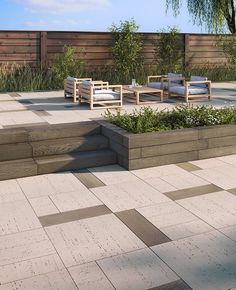 an outdoor seating area with wooden benches and planters