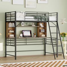 a loft bed with desk underneath it in a room that has light green walls and wooden flooring