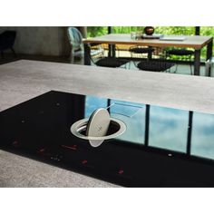 a black table with a glass top and an electronic device on it's surface