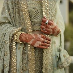 a close up of a person wearing a wedding dress and holding her hands on their chest