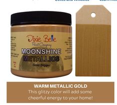 a jar of gold metallic paint next to a wooden tag