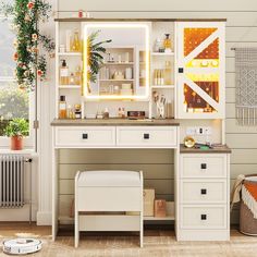 a bathroom with a vanity, mirror and stool next to a plant on the wall