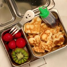 a lunch box filled with fruit and waffles