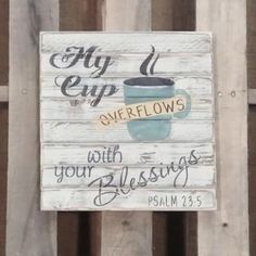 a sign that says, fly cup overflows with your blessing on the side of a wooden fence