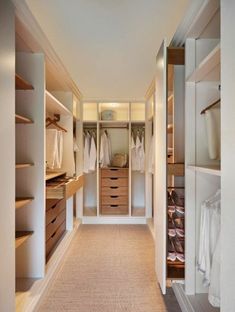 an empty walk in closet with lots of drawers