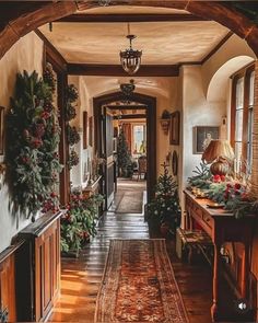 the hallway is decorated for christmas with wreaths and greenery