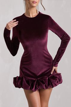 Opt for opulence at your next social event in our port mini dress. Claudine. Crafted in our signature stretch velvet. this long-sleeved bodycon is characterised by an extravagant display of ruffles along its hemline. Keep Claudine at the forefront during your next birthday soiree by pairing it with a sleek bun and gold accents. Features - Premium stretch velvet- Bodycon fit - Crew neckline - Padded shoulders- Long sleeves- Invisible zip closure - Ruffled hemline - Mini length Sizing & Fit Model is 5'7" and wears US size 4 / UK size 8 Product Information Designed exclusively by Club L London Fully lined with good stretch Premium velvet in Port (92% Polyester. 8% Elastane) 85cm total length SKU: CL128798101