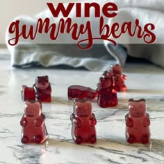 several gummy bears sitting on top of a marble counter with the words wine gummy bears