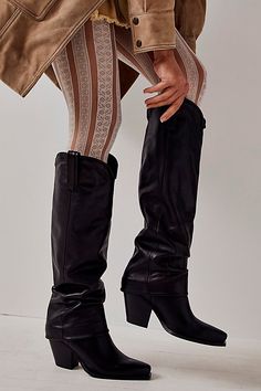 Saddle up with these sleek Western-inspired boots, featured in a tall style and slouchy design for an ultra-cool twist. **Features:** Tall style, pull-on design, Western-inspired silhouette, leather fabrication, pointed toe, slouchy ankle details, pull straps, block heel**Why We <3 It:** Wear these boots with some tights and a sleek mini for an ultra elevated look.