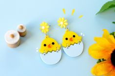 "♥ Hatching Chick Earrings ♥ This pretty pair of earrings is perfect for cool chicks, chicken owners, birds and animal lovers and earring ethusiasts! Some key features: ♥ Laser cut with bright, uplifting yellow acrylic with a pretty yellow flower. ♥ bottom half swings playfully and you will fall in love with the cute chick's chirp! ♥ Designed, crafted and packaged in Sehreen's Art Lab ♥ Size of the earrings: 2.5\" ♥ Materials: Acrylic See more cute pins and earrings at my shop here! etsy.com/sho Playful Earrings For Spring Gift, Playful Earrings With Cute Design As Gift, Whimsical Earrings For Spring Gift, Cute Spring Earrings With Ear Wire, Whimsical Spring Earrings For Gift, Cute Yellow Earrings For Spring, Fun Dangle Earrings For Spring, Handmade Fun Earrings For Spring, Playful Yellow Hypoallergenic Earrings