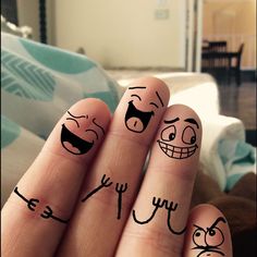 two fingers with faces drawn on them