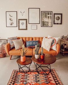 a living room filled with lots of furniture and pictures on the wall above it's coffee table