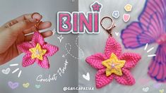 two crocheted stars are being held up by someone's hand with the word bin on it