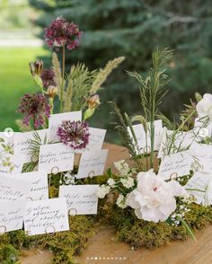 flowers and place cards are placed on the table for guests to write their names in