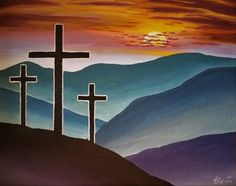 three crosses on top of a hill with the sun setting in the distance behind them