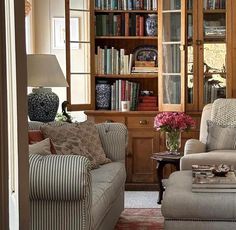 a living room filled with furniture and bookshelves