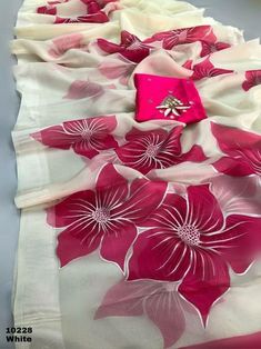 a pink and white flower print scarf