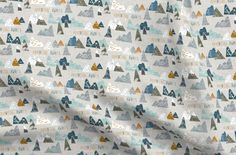 an image of a fabric with mountains and trees in grey, yellow and blue colors