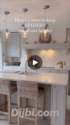 a kitchen with two stools and an island in the middle, surrounded by white cabinets