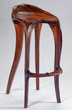 a wooden stool with curved legs on a white background