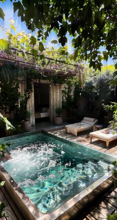 an outdoor hot tub surrounded by greenery