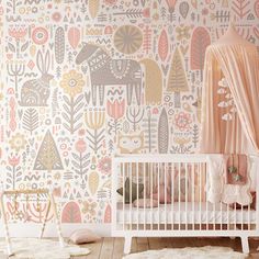 a baby's room decorated in pink, orange and white with an elephant wallpaper