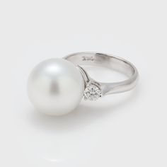 Metal: 18k white gold Gem: South Sea Pearl Accents: Diamonds 0.5ctw Size: 6.5 Timeless White Ring With Tension Setting, White Timeless Ring With Tension Setting, Timeless White Gold Pearl Ring With Diamond Accents, Timeless White Gold Pearl Ring With Diamonds, Formal Brilliant Cut Pearl Ring In Platinum, White Platinum Diamond Ring Fine Jewelry, Classic White Gold Pearl Ring With Diamond Accents, Platinum Pearl Ring In Diamond White For Anniversary, Diamond White Pearl Ring With Brilliant Cut