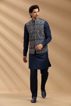 Top Details Color- Navy Blue, Fabric - Soft Suiting Fabric With Embroidered Bottom Details Color- Black, Fabric - Suiting Fabric, Style - Aligadi Pajama Package Include :INCLUDES 1 BANDI,1 KURTA,1 ALIGADI. Turban ,Mojari And Other Accessories Are Not Sold Along With The Dress. CARE: DRY CLEAN ONLY Additional Information : - As This Sherwani/Waistcoat/Kurta Are Made As Per Orders So It Is Strictly Not Acceptable Once Get Delivered .So Kindly Choose Body Fit Size . Also We Keep 2 Inches Extra Margin In The Dress. Blue Straight Kurta Bandhgala For Navratri, Blue Nehru Jacket With Chikankari Embroidery For Festivals, Blue Nehru Jacket With Zari Work, Festive Blue Nehru Jacket With Cutdana, Traditional Blue Nehru Jacket In Straight Kurta Style, Blue Nehru Jacket Straight Kurta For Festivals, Blue Nehru Jacket For Festivals, Straight Kurta Style, Blue Nehru Jacket For Festivals, Blue Bollywood Nehru Jacket Straight Kurta