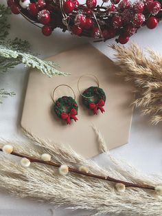 HANDMADE CHRISTMAS WREATH HOOP DANGLE POLYMER CLAY EARRINGS ♡ All items are designed and handcrafted by myself, using quality light weight polymer clay. A ton of love goes into making each and every pair, therefore small blemishes may occur. These earrings are finished with either gold or silver hoops. All colours are hand mixed by myself, so may differ slightly from images. PREMIUM  All earrings are made using high quality polymer clay, nickel-free & lead-free stainless steel posts and findings Polymer Clay Wreath Earrings, Clay Wreath, Christmas Polymer Clay Earrings, Christmas Polymer Clay, Wreath Earrings, Handmade Christmas Wreaths, Clay Christmas, Christmas Clay, Polymer Clay Christmas