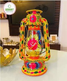 a brightly colored lantern sitting on top of a table