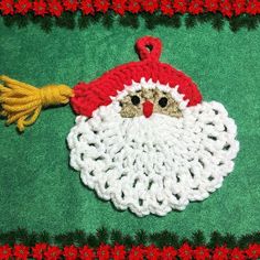 a crocheted christmas ornament with a santa clause on it's face