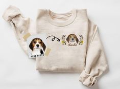 a white sweater with a brown and black dog on it's chest next to a photo of a beagle