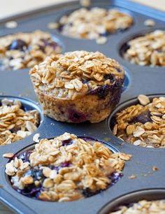 muffins with blueberries and oats are in a muffin tin ready to be eaten