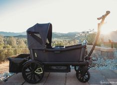 a baby stroller sitting on top of a sidewalk