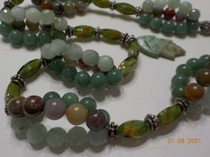 "Vintage 22\" beaded necklace with a 1 1/4\" leaf. Glass beads, jade beads, aventurine beads, and miscellaneous jasper. This is gorgeous & in excellent condition. The silver tone interlocking fastener has been replaced by a local professional jeweler. Gorgeous!! Unsigned." Aventurine Gemstone Beads Necklace For Healing, Green Aventurine Beaded Hand-strung Necklace, Spiritual Green Aventurine Beaded Necklace, Green Aventurine Beaded Necklaces For Meditation, Green Aventurine Beaded Necklace For Meditation, Unicorn Pendant, Pearl Pendant Necklace, Jade Beads, Plastic Beads