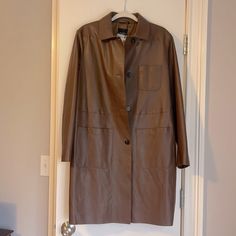 Brand New With Tags, Maxmara Brown Leather Weekend Trench Jacket. Size Us 12. Extra Button Still Attached. Perfect Condition. Original Retail Price Is $1,100.00 Elegant Leather Jacket With Snap Buttons, Brown Outerwear With Covered Buttons For Work, Elegant Brown Leather Jacket With Pockets, Luxury Brown Leather Outerwear, Oversized Brown Leather Outerwear, Luxury Vintage Brown Leather Outerwear, Brown Long-sleeved Outerwear With Button Closure, Brown Long-sleeved Leather Outerwear, Leather Trench