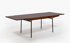 a wooden table with black metal legs on a white background