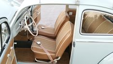 the interior of an old car with tan leather seats and beige dash tape on the floor