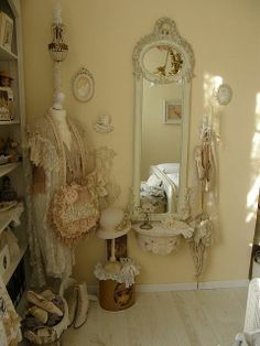 a room filled with lots of white furniture and decor on top of hard wood flooring