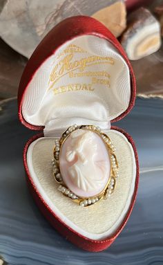 Item: Antique 10K Yellow Gold Natural Pearl Framed Cameo Brooch Pendant for Necklace. This is stamped 10K. The display box shown in the photos is not included. The chain is for demonstration purposes only and is not included. Measurements: 1 & 3/8th inches tall (including the bale). 1 inch wide. It weighs 6.49 grams. Condition: Antique, previously owned. There is no damage to note. There may be very minor signs of age/use. Please see our other listings, we combine shipping for savings. Heirloom Engraved Brooches For Gifts, Heirloom Cameo Brooch Gift, Heirloom Cameo Brooches For Gifts, Heirloom Cameo Brooches As Gift, Heirloom Brooches With Cabochon For Gifts, Heirloom Oval Brooches For Gifts, Heirloom Oval Brooches As Gift, Antique Cameo Jewelry, Historic Jewelry