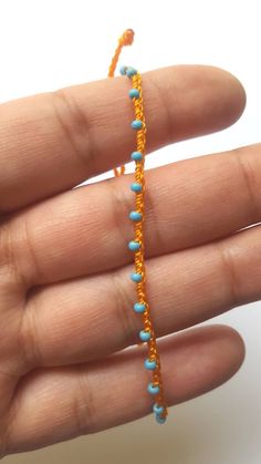 "♡Listing is for one dainty seed bead bracelet or anklet as featured and your choice of card♡ Perfect for everyday wear. Super dainty and minimalist look. Great way to add a little color to any outfit. Makes a very dainty stacking bracelet too. *Featured: Cord color-Tangerine Beads- Sky Blue Closure- A. With Beads *Material: Item is made with sturdy nylon cord. The cord resembles silk and color will not fade away. Tiny glass seed beads are carefully hand braided as the highlight of this item. *C Blue Beaded Chain Anklets As Gift, Blue Beaded Chain Anklets For Gift, Blue Tiny Beads Anklet For Gift, Blue Anklet With Tiny Beads For Gift, Dainty Beaded Chain Anklets With Round Beads, Minimalist Handmade Anklets With Round Beads, Handmade Turquoise Anklet Bracelet, Blue Anklets With Tiny Beads, Minimalist Handmade Beaded Anklets