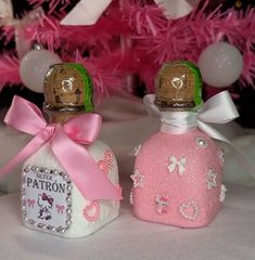 two small bottles with pink and white designs on them