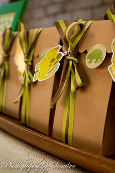 some brown paper bags with green ribbons on them