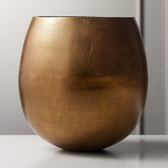 a large metal bowl sitting on top of a table next to a wall and door