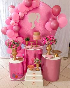 a pink and gold birthday party with balloons, cake, decorations and decorating items