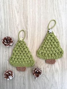 two crocheted christmas trees with pine cones